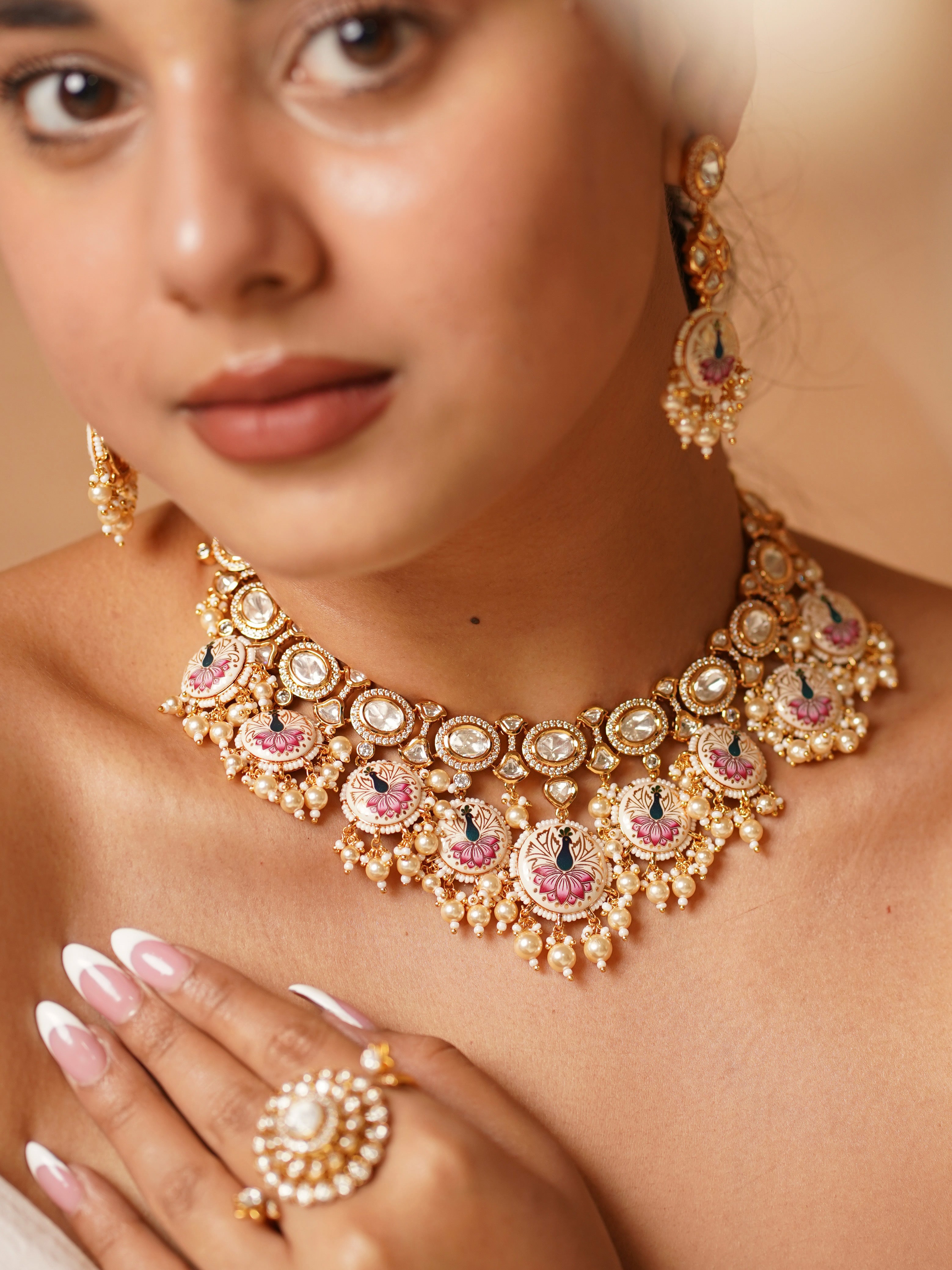 Angled view of enamel peacock necklace and matching pushback earrings